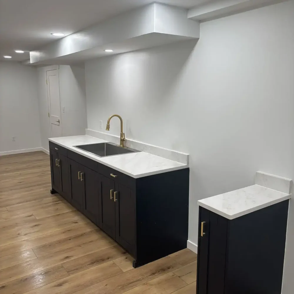 Remodeled Basement Area with Marble Countertops and Dark Wood Cabinetry